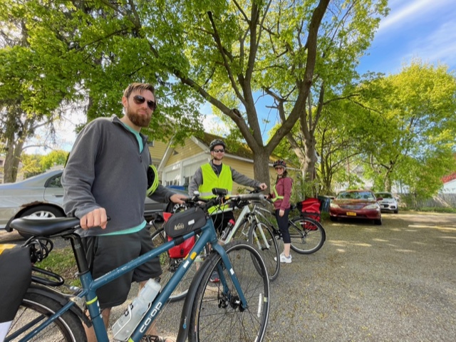 Myself and two others  standing with our bikes in a driveway.
